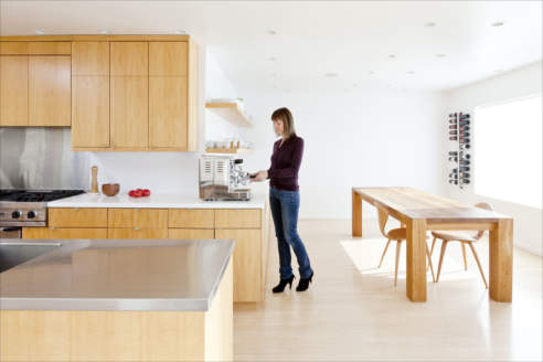 Interior / architectural photograph of a woman in her kitchen